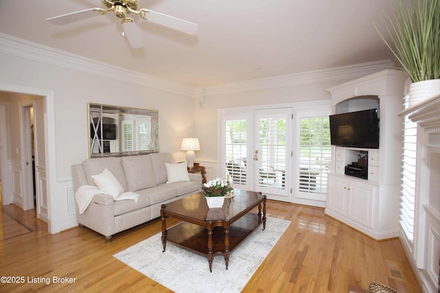 1304 Isleworth Dr, Louisville, KY 40245 - living area with crown molding, a decorative wall, light wood finished floors, ceiling fan, and wainscoting