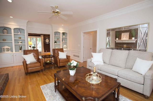 1304 Isleworth Dr, Louisville, KY 40245 - living area with crown molding, built in shelves, light wood finished floors, ceiling fan, and a brick fireplace