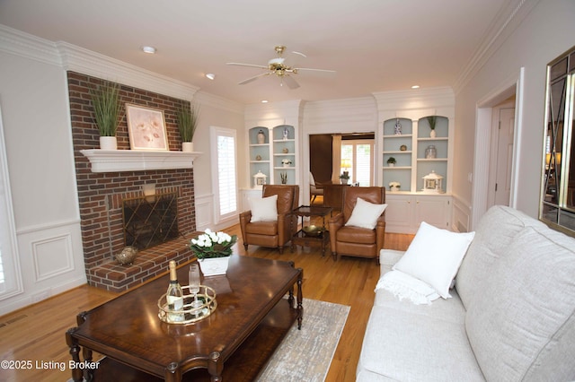 1304 Isleworth Dr, Louisville, KY 40245 - living area featuring light wood-style flooring, built in shelves, healthy amount of natural light, a ceiling fan, and crown molding