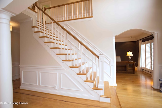 1304 Isleworth Dr, Louisville, KY 40245 - staircase featuring ornate columns, arched walkways, wood finished floors, and crown molding