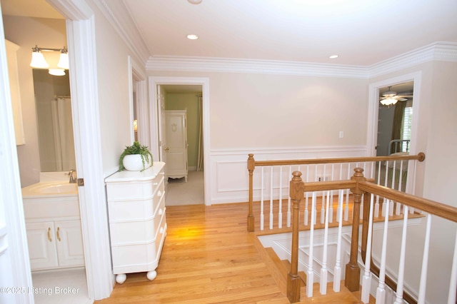 1304 Isleworth Dr, Louisville, KY 40245 - corridor featuring an upstairs landing, a sink, light wood-style flooring, ornamental molding, and wainscoting