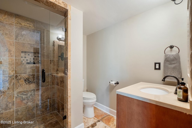 full bath featuring tile patterned flooring, toilet, vanity, baseboards, and a stall shower