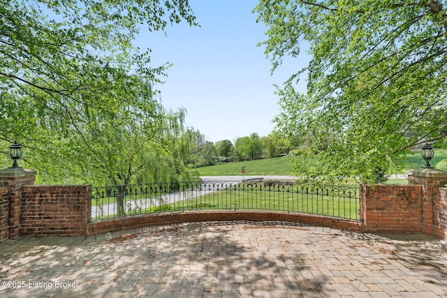 view of gate featuring a yard