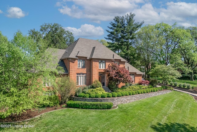 view of front of house with brick siding and a front yard