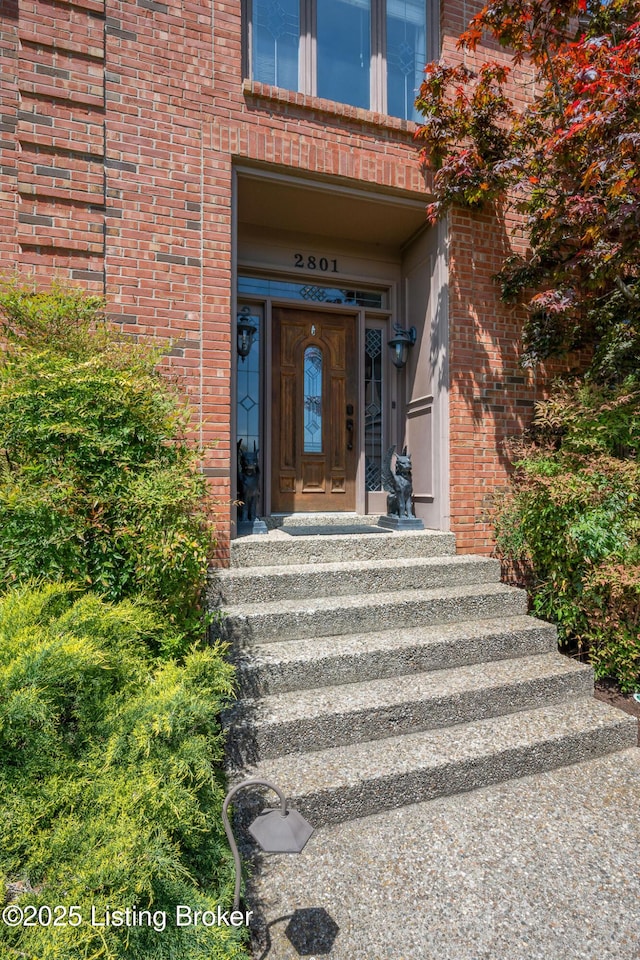 property entrance featuring brick siding