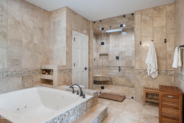 full bath featuring tile walls, a tub with jets, and a shower stall