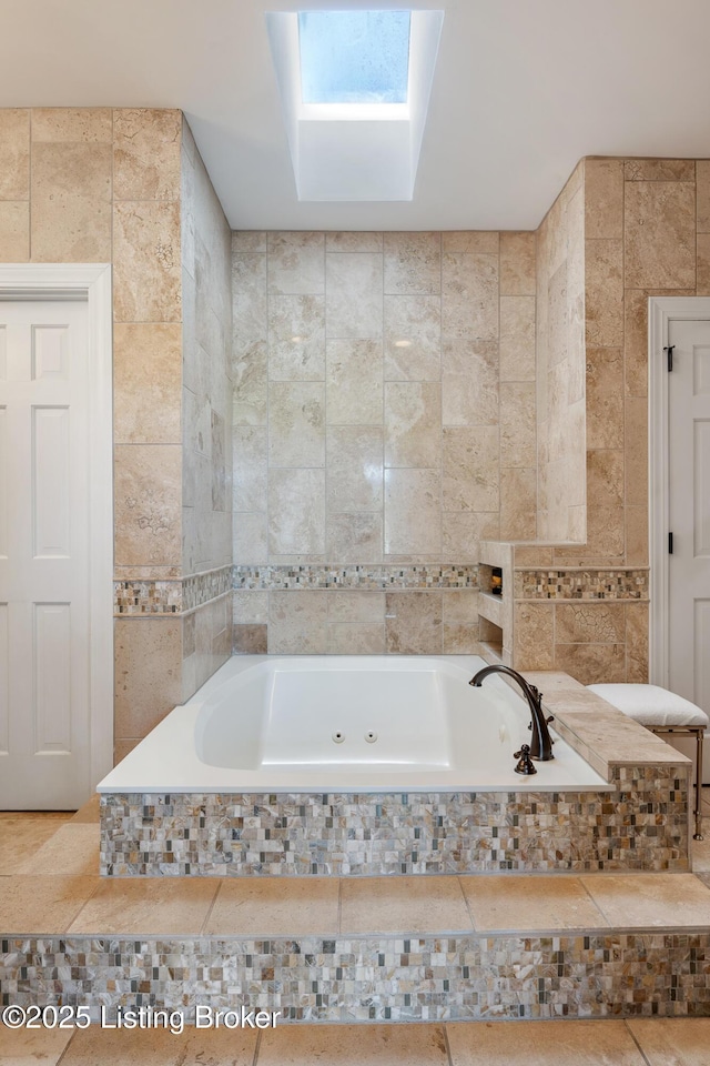 full bath featuring a tub with jets and tile walls