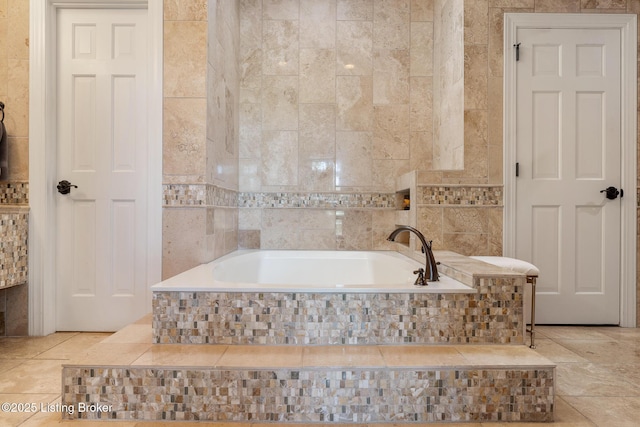 bathroom featuring a garden tub and tile walls