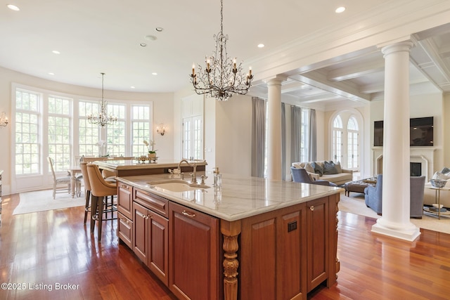 kitchen featuring a chandelier, plenty of natural light, dark wood-style flooring, recessed lighting, and a kitchen island with sink