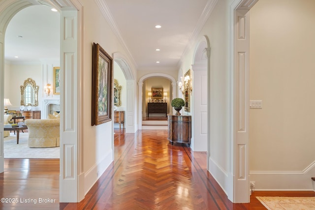 corridor featuring arched walkways, crown molding, and recessed lighting