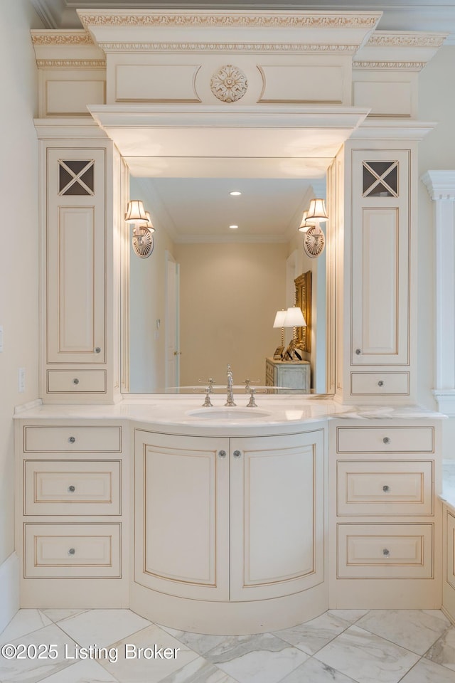 bathroom with marble look tile flooring, vanity, and ornamental molding