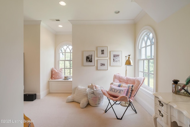 sitting room with carpet floors, plenty of natural light, crown molding, and recessed lighting