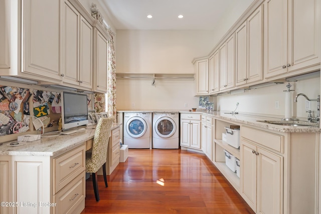 laundry room featuring washing machine and dryer, cabinet space, light wood-style flooring, recessed lighting, and an office area