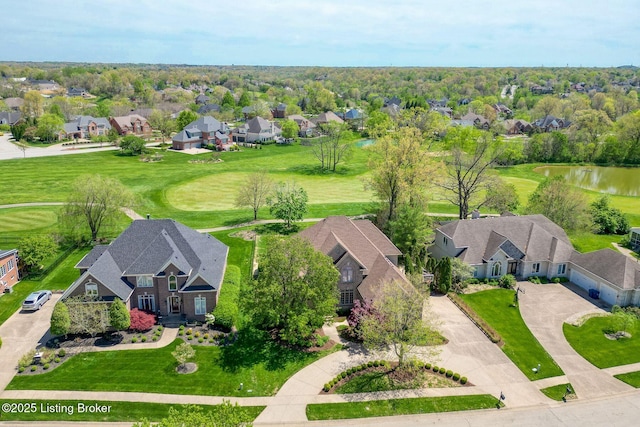 drone / aerial view with a residential view, a water view, and view of golf course