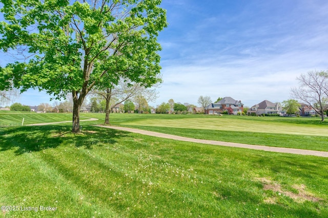 surrounding community with a residential view and a lawn