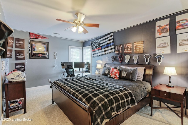 carpeted bedroom featuring baseboards, visible vents, and a ceiling fan