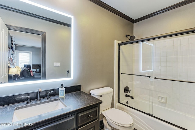 full bathroom featuring crown molding, toilet, shower / bath combination with glass door, and vanity