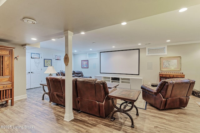 home theater with ornamental molding, recessed lighting, baseboards, and light wood-style floors