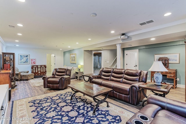 living room featuring visible vents, crown molding, light wood-style flooring, and recessed lighting