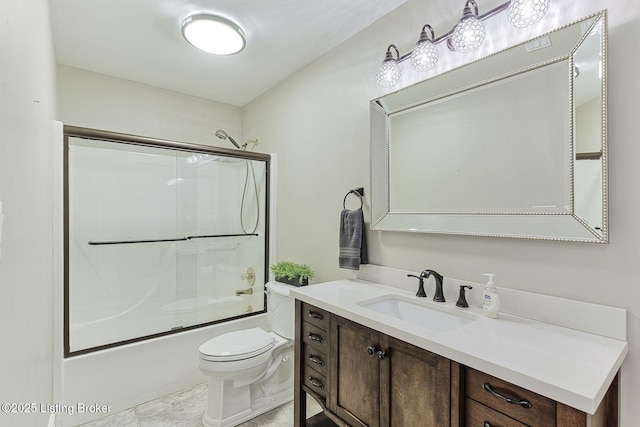 bathroom with toilet, vanity, and shower / bath combination with glass door