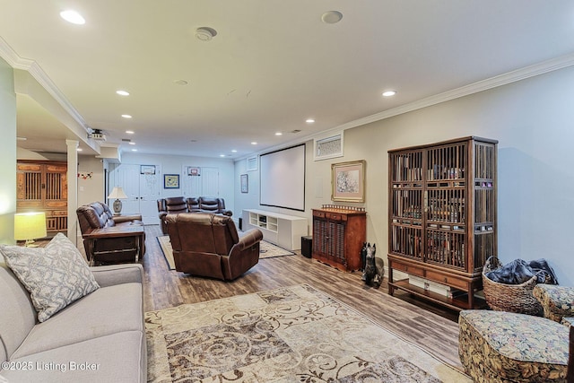 living area with recessed lighting, wood finished floors, and crown molding