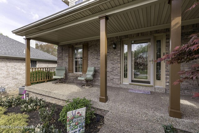 view of patio / terrace with central air condition unit and a porch