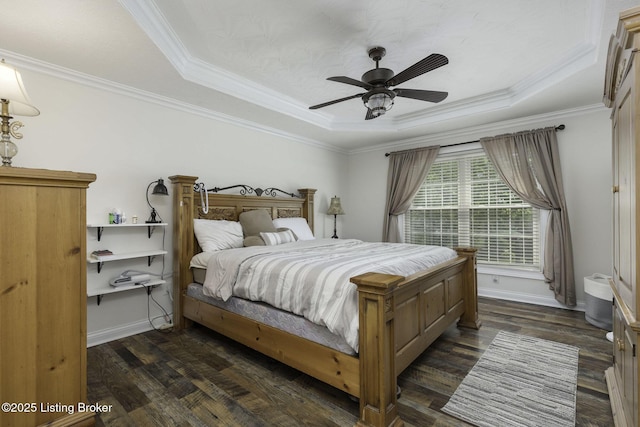 bedroom with crown molding, baseboards, a tray ceiling, and dark wood-style flooring