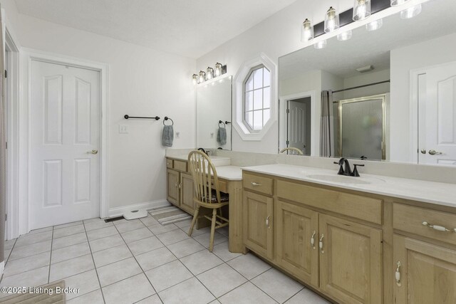 bathroom with a shower stall, baseboards, tile patterned flooring, and vanity