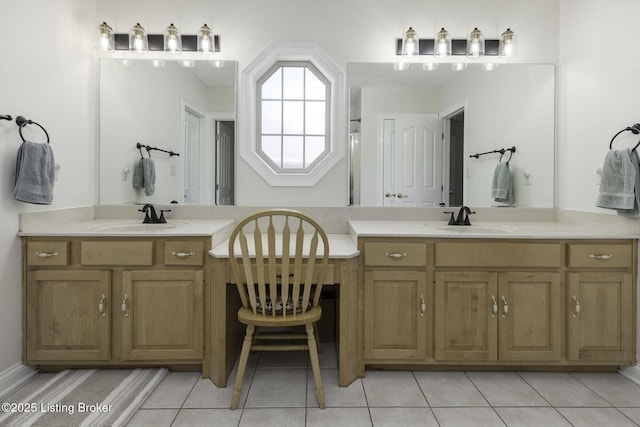 bathroom with two vanities, tile patterned floors, and a sink