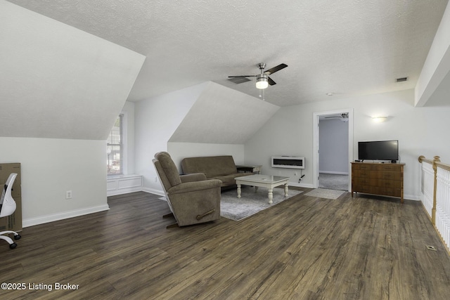 living room with vaulted ceiling, baseboards, heating unit, a ceiling fan, and dark wood-type flooring