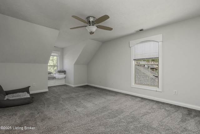 bonus room with ceiling fan, carpet floors, lofted ceiling, and visible vents