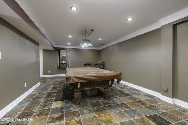 dining room featuring ornamental molding, baseboards, and stone tile flooring