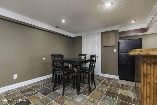 dining area with stone tile flooring, a textured ceiling, baseboards, and ornamental molding