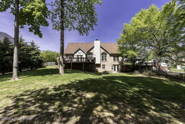 view of yard featuring a wooden deck and fence