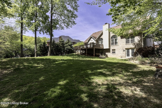 view of yard featuring a wooden deck, french doors, and stairs