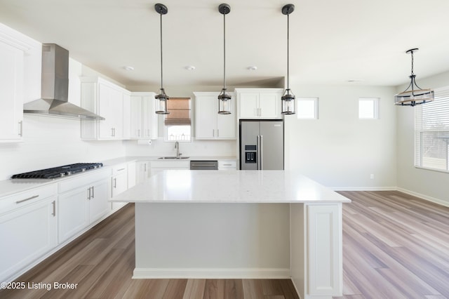 3611 Fordham Pk Dr, Louisville, KY 40245 - kitchen with stainless steel appliances, wall chimney range hood, tasteful backsplash, and wood finished floors