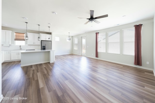3611 Fordham Pk Dr, Louisville, KY 40245 - unfurnished living room with a sink, plenty of natural light, a ceiling fan, and wood finished floors