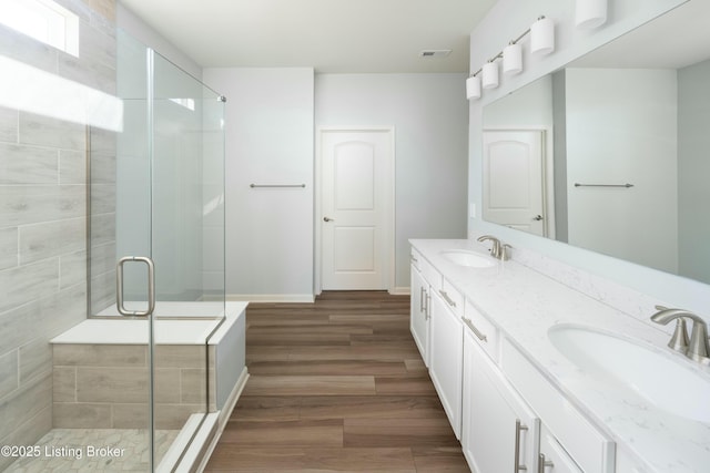 3611 Fordham Pk Dr, Louisville, KY 40245 - bathroom with double vanity, wood finished floors, and a shower stall