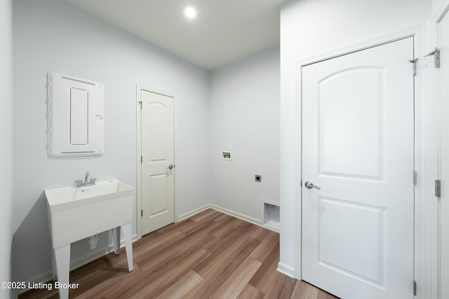 3611 Fordham Pk Dr, Louisville, KY 40245 - laundry area with hookup for an electric dryer, light wood-style flooring, electric panel, hookup for a washing machine, and baseboards