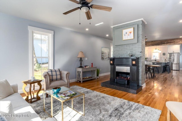 306 E Washington St, La Grange, KY 40031 - living room featuring a ceiling fan, light wood-type flooring, a fireplace, baseboards, and recessed lighting