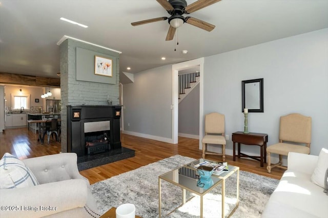 306 E Washington St, La Grange, KY 40031 - living room with stairway, wood finished floors, a ceiling fan, a multi sided fireplace, and baseboards