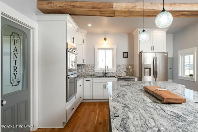 306 E Washington St, La Grange, KY 40031 - kitchen with white cabinets, wood finished floors, stainless steel appliances, and a sink