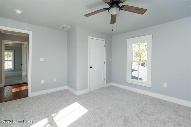 306 E Washington St, La Grange, KY 40031 - unfurnished bedroom featuring visible vents, carpet flooring, baseboards, and multiple windows