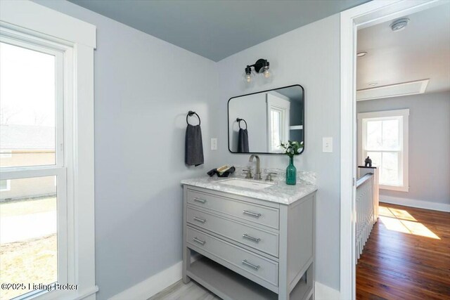 306 E Washington St, La Grange, KY 40031 - bathroom featuring wood finished floors, baseboards, and vanity