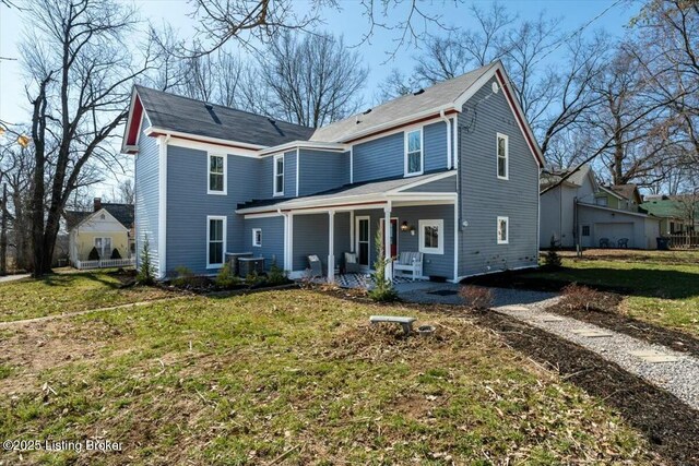 306 E Washington St, La Grange, KY 40031 - view of front facade featuring central AC, a porch, and a front lawn