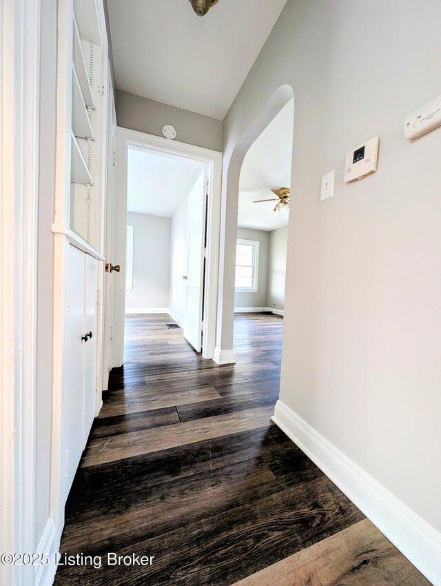 1104 Oleanda Ave, Louisville, KY 40215 - corridor featuring arched walkways, baseboards, and dark wood-style floors