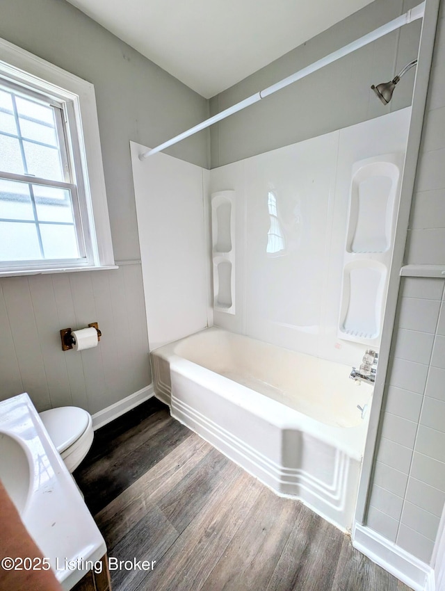1104 Oleanda Ave, Louisville, KY 40215 - bathroom featuring wood finished floors, shower / tub combination, toilet, and a wainscoted wall