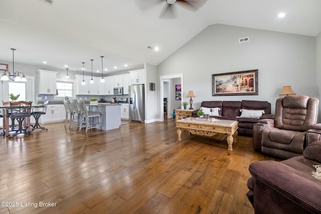 living room with a ceiling fan, visible vents, recessed lighting, and dark wood finished floors