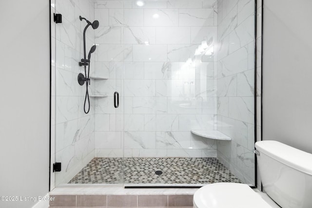 full bath featuring toilet and a stall shower