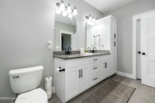 full bathroom with toilet, tile patterned floors, a sink, and double vanity